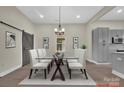 Elegant dining room with glass-top table, modern chairs, and a sliding barn door at 126 Hemphill Ave, Chester, SC 29706