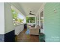 Inviting covered porch with comfortable seating, ceiling fan, and classic railings, perfect for relaxing at 1327 Fairmont St, Charlotte, NC 28216