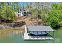 Waterfront property with private dock, boat lift and covered area for boat storage at 153 High Hills Dr, Mooresville, NC 28117