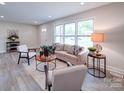 Inviting living room with modern furnishings, light wood flooring, and abundant natural light at 163 Briarcliff Dr, Kannapolis, NC 28081