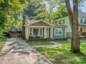 Delightful single-story home with inviting entrance, beautiful landscaping and convenient private driveway at 1720 Chatham Ave, Charlotte, NC 28205