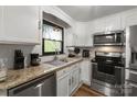 Updated kitchen with granite countertops, stainless steel appliances and modern white cabinets at 173 8Th Ave, Conover, NC 28613