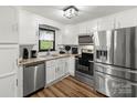 Bright and modern kitchen with stainless steel appliances, white cabinets, and granite countertops at 173 8Th Ave, Conover, NC 28613