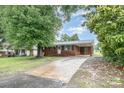 A single-story brick home with a long driveway and carport at 2218 W Fifth Ave, Gastonia, NC 28052