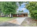 Beautiful one-story brick home with a large driveway and inviting covered carport at 2218 W Fifth Ave, Gastonia, NC 28052