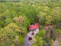 Aerial view of a house with a red roof, surrounded by lush greenery and a long, paved driveway at 2599 Highway 557 None, Clover, SC 29710