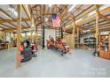 Inside a huge garage with wooden beams, an American flag, and lots of room for vehicles at 2599 Highway 557 None, Clover, SC 29710