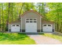 Spacious three car garage with white doors and a red roof, surrounded by trees at 2599 Highway 557 None, Clover, SC 29710