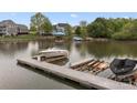 Picturesque waterfront view featuring a boat dock on a serene lake setting at 263 Fernbrook Dr, Mooresville, NC 28117