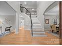 Spacious foyer with a staircase and hardwood floors creating an inviting entryway at 263 Fernbrook Dr, Mooresville, NC 28117