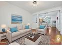 Cozy living room showcasing hardwood floors, natural light, and access to the dining area at 2731 Meadow Knoll Dr, Charlotte, NC 28269