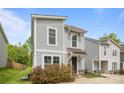 Charming two-story home featuring a gray siding, stylish windows, and a well-manicured front yard at 2821 Shamrock Dr, Charlotte, NC 28205