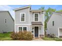 Charming two-story home featuring a gray siding, stylish windows, and a well-manicured front yard at 2821 Shamrock Dr, Charlotte, NC 28205