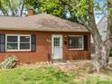 A cozy brick home with manicured lawn, flowering bushes, and an inviting front door at 330 Clover St, Mooresville, NC 28115