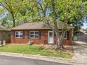 Charming single-story brick house featuring a well-manicured lawn and mature shade trees at 330 Clover St, Mooresville, NC 28115
