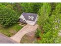 Aerial view of a cozy home surrounded by mature trees and a well-manicured lawn at 3509 Seminole Dr, Maiden, NC 28650