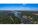 Aerial view of a lakefront property at 378 Shoreline Drive surrounded by lush greenery at 378 Shoreline Dr, New London, NC 28127