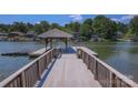 Scenic view from the dock with a charming covered boat slip on a tranquil lake at 378 Shoreline Dr, New London, NC 28127