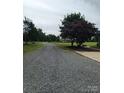 Gravel driveway leads to a home with mature trees at 4330 Goodman Lake Rd, Salisbury, NC 28146