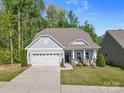 Charming single-story home with a manicured lawn, attached two car garage and welcoming front porch at 4607 Walking Path Dr, Waxhaw, NC 28173