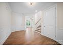 Spacious foyer with hardwood floors, staircase, and plenty of natural light, creating a welcoming entrance at 5028 Whitemarsh Ct, Indian Land, SC 29720