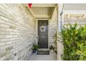 Inviting front entrance with decorative wreath, potted plants, and brick exterior, adding curb appeal at 5028 Whitemarsh Ct, Indian Land, SC 29720