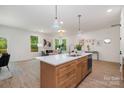 Kitchen island with a stainless steel sink, and seating in an open concept living space at 503 5Th Avenue Ne Ave, Conover, NC 28613