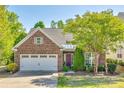 Charming brick home featuring a well-maintained front yard and attached garage at 5050 Kinross Ln, Indian Land, SC 29707