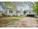 Backyard featuring a detached garage, patio, and spacious lawn at 627 N Flint St, Lincolnton, NC 28092