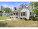 Classic single-story home with a quaint front porch, dark shutters, and a tidy landscaped yard at 627 N Flint St, Lincolnton, NC 28092