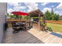 Outdoor back deck with built in grill and large table, perfect for entertaining guests and relaxing outside at 7397 Mill Ruins Sw Ave, Concord, NC 28025