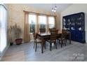 The dining area boasts lots of natural light, colorful wall decor and a classic china cabinet at 7397 Mill Ruins Sw Ave, Concord, NC 28025