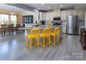 Bright, open kitchen featuring stainless steel appliances, granite countertops, and a large island with bar seating at 7397 Mill Ruins Sw Ave, Concord, NC 28025