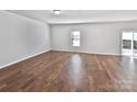 Spacious living room with wood floors and sliding doors to the outdoor area at 805 Gunnar Dr, Gastonia, NC 28054