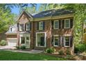Charming two-story brick home with manicured lawn and mature trees, showcasing classic architectural details at 902 Hoke Trl, Cramerton, NC 28032