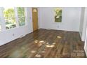 Inviting living room with hardwood floors, large windows, and freshly painted walls, creating a cozy atmosphere at 906 N 11Th St, Albemarle, NC 28001
