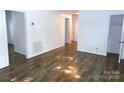 Bright living room featuring beautiful hardwood floors, fresh white paint, and ample natural light at 906 N 11Th St, Albemarle, NC 28001