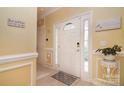 Inviting foyer with tiled floor, white door, and 'Home Sweet Home' decor at 9106 Dogwood Ridge Dr, Charlotte, NC 28227