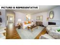 Spacious living area featuring hardwood floors, a cozy fireplace, and ample natural light at 103 Way Cross Ln, Troutman, NC 28166