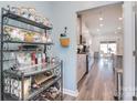 Hallway view into the kitchen, showcasing open layout and decorative shelving at 11616 Solstice Way, Huntersville, NC 28078