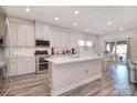 Bright, open kitchen featuring white cabinets, quartz countertops, and stainless steel appliances at 11616 Solstice Way, Huntersville, NC 28078
