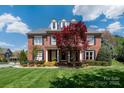 Elegant brick home featuring a well-manicured lawn, professional landscaping, and traditional design at 12122 Camden Trail Ct, Charlotte, NC 28277