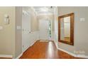 Inviting foyer featuring hardwood floors, decorative mirror, and crown molding at 13505 Michael Lynn Rd, Charlotte, NC 28278