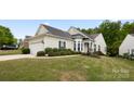 Charming home featuring a well-manicured lawn, attached two-car garage, and inviting architectural details at 1488 River Bend Blvd, Fort Mill, SC 29707