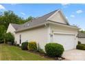 Home featuring an attached two-car garage, manicured lawn, and mature trees at 1488 River Bend Blvd, Fort Mill, SC 29707