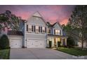 Charming two-story home with a three-car garage and well-manicured lawn and front garden at 2002 Thurston Dr, Indian Trail, NC 28079