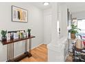 Hallway features a decorative table with plants and artwork, and wood flooring at 212 W 10Th St # 17, Charlotte, NC 28202
