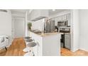 Kitchen featuring an eat-in bar with granite countertops, stainless steel appliances and wooden floors at 212 W 10Th St # 17, Charlotte, NC 28202
