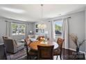 Cozy dining room area features a round dining table with seating for four under a beautiful chandelier at 221 Sycamore Creek Rd, Fort Mill, SC 29708