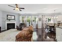 Spacious living room features a fireplace, hardwood floors, large windows, and an adjacent dining area at 221 Sycamore Creek Rd, Fort Mill, SC 29708